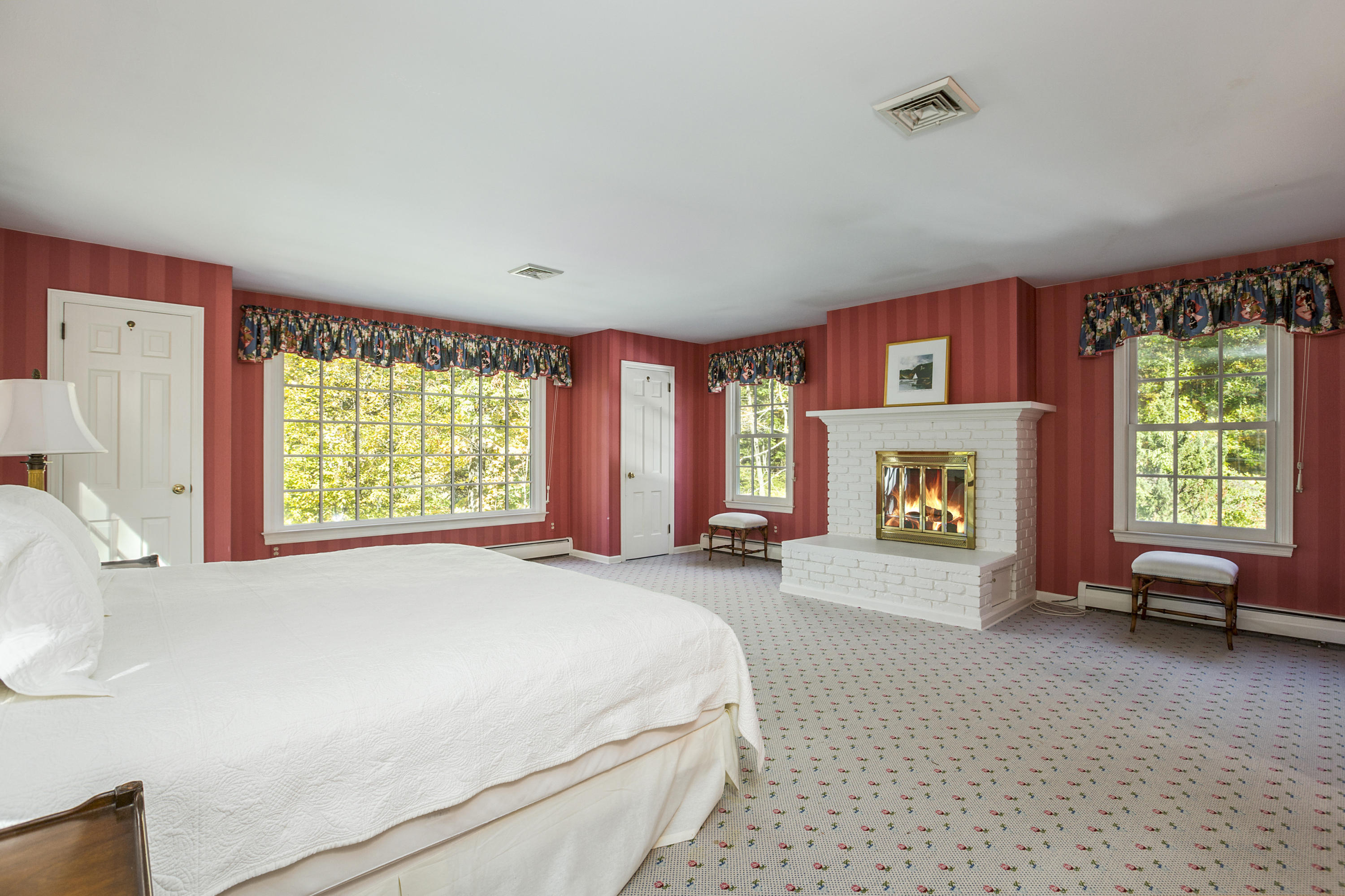 75 Delafield Island Road Darien, CT 06820 - Photo 16 of 28 a spacious bedroom with a bed and a couch