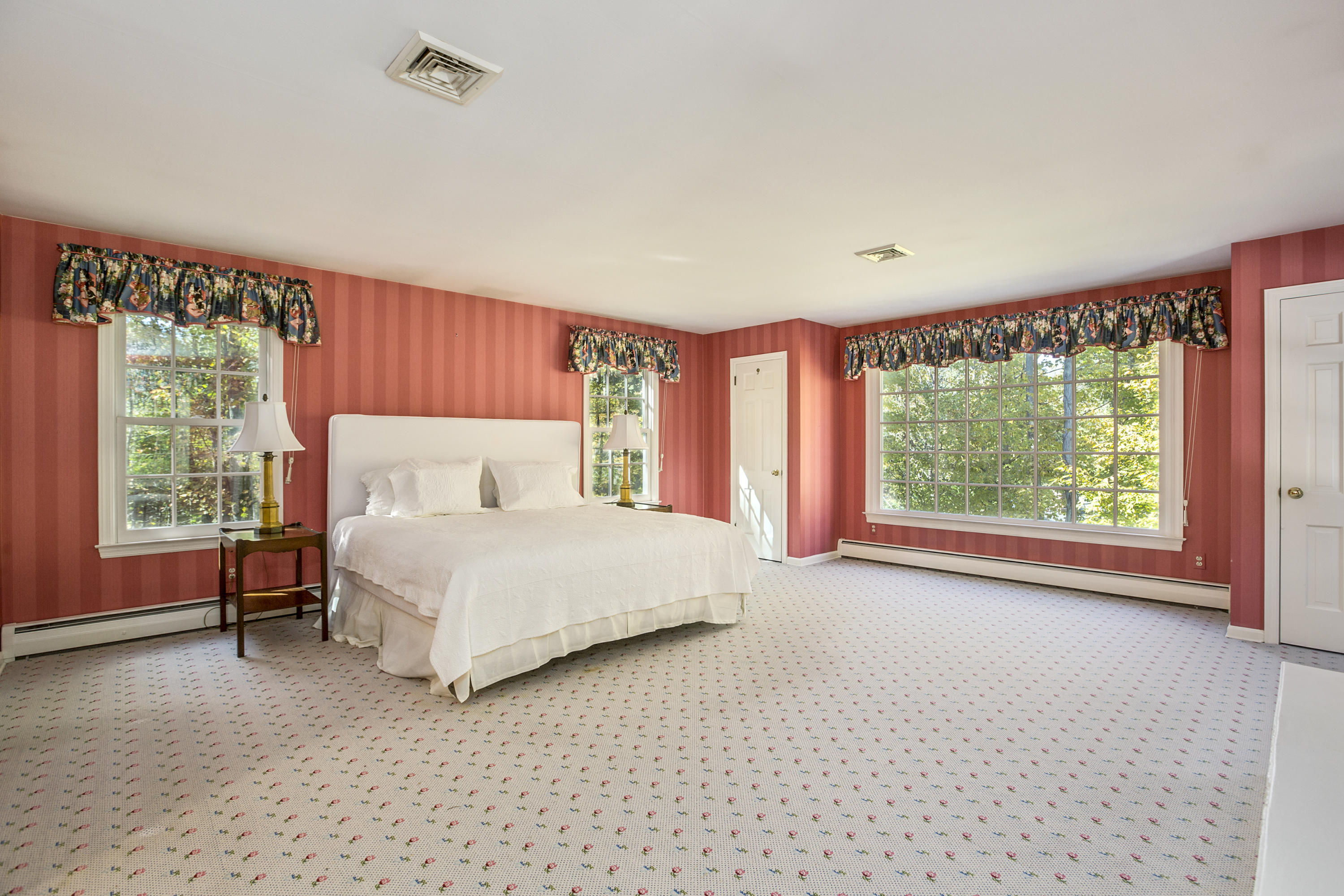 75 Delafield Island Road Darien, CT 06820 - Photo 17 of 28 a bedroom with a large bed and a large window