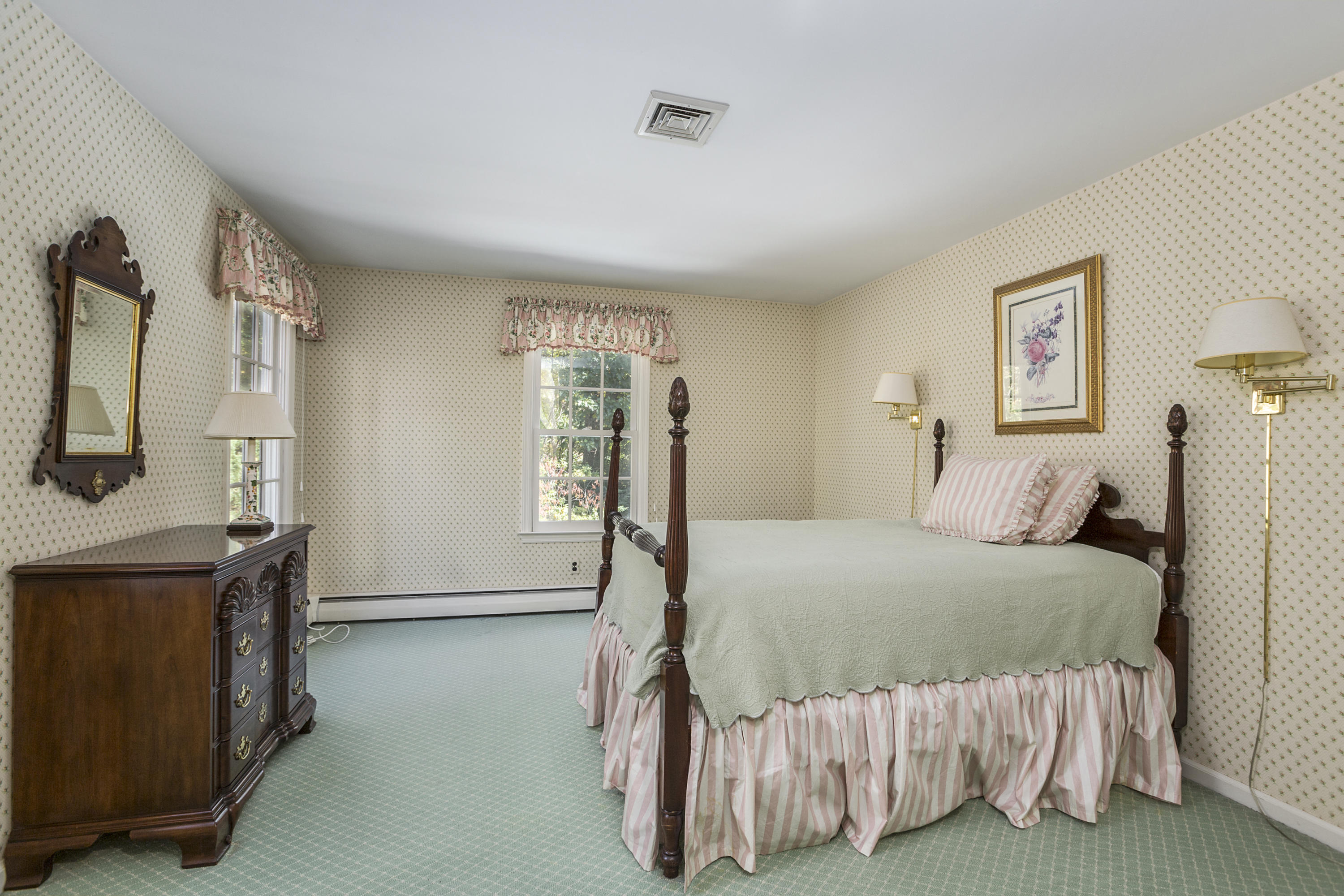 75 Delafield Island Road Darien, CT 06820 - Photo 22 of 28 a bedroom with a bed and a flat tv screen on dresser