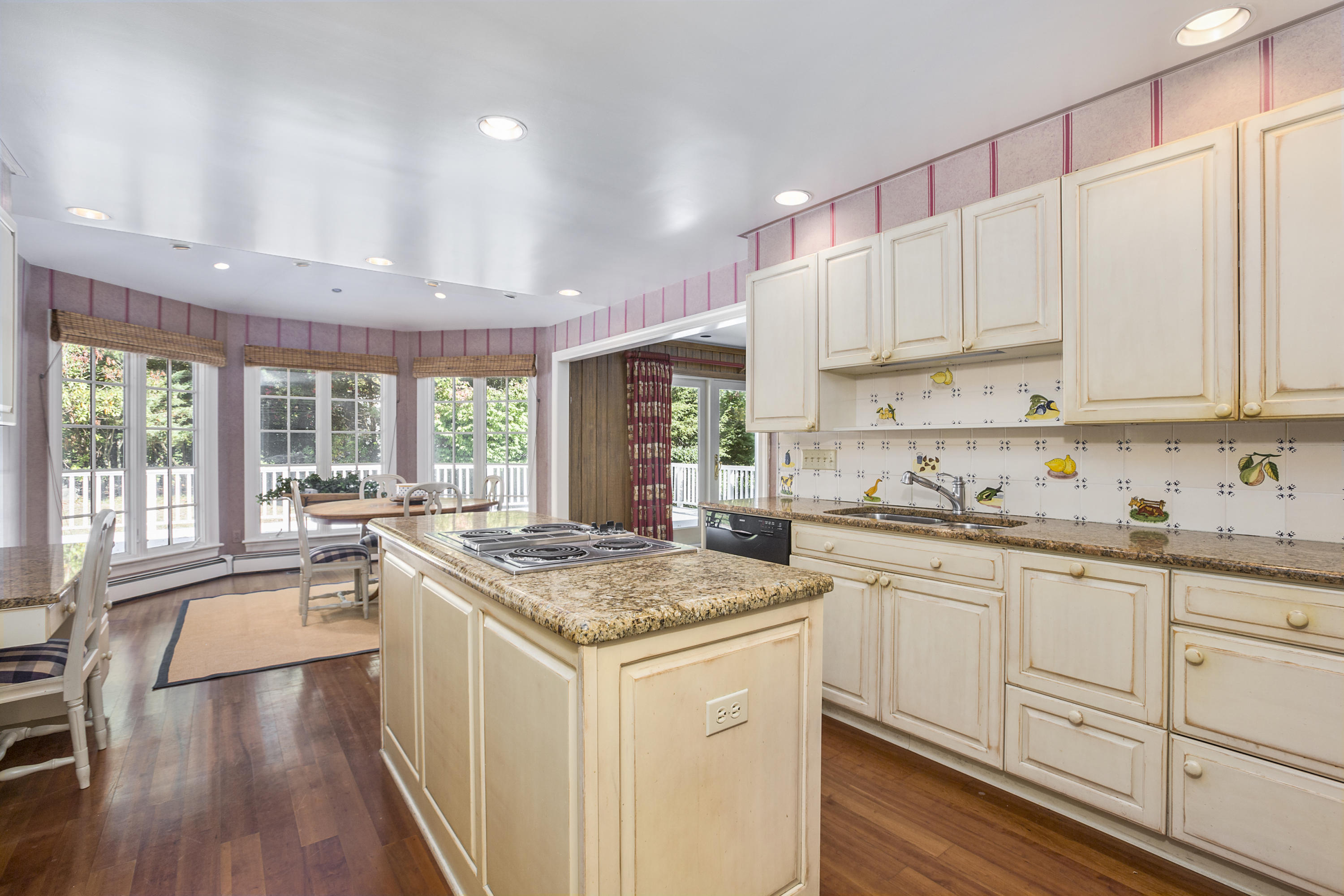 75 Delafield Island Road Darien, CT 06820 - Photo 8 of 28 a kitchen with granite countertop white cabinets and white appliances