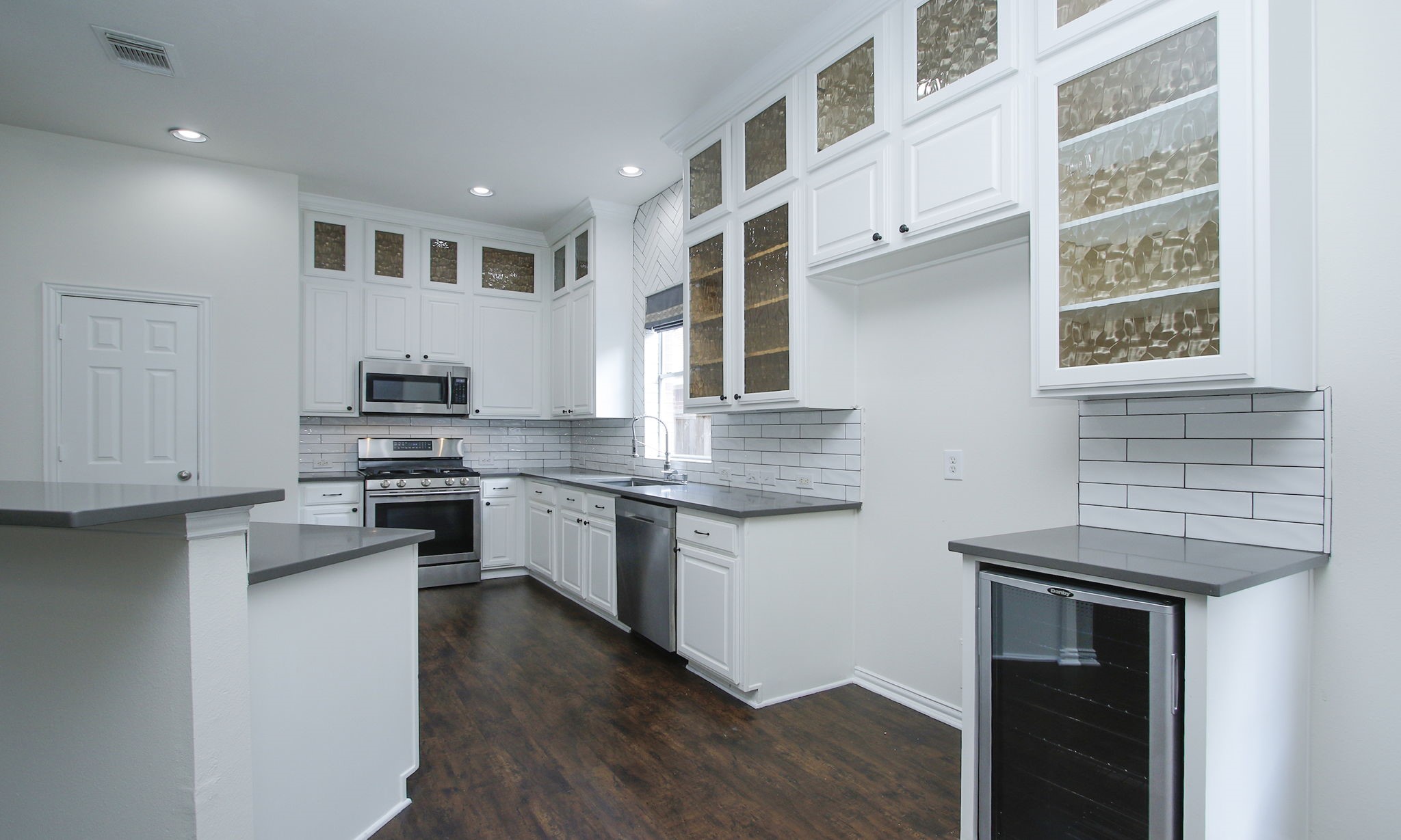1210 Berwick Manor Court Spring, TX 77379 - Photo 23 of 50 a kitchen with stainless steel appliances a sink stove and cabinets