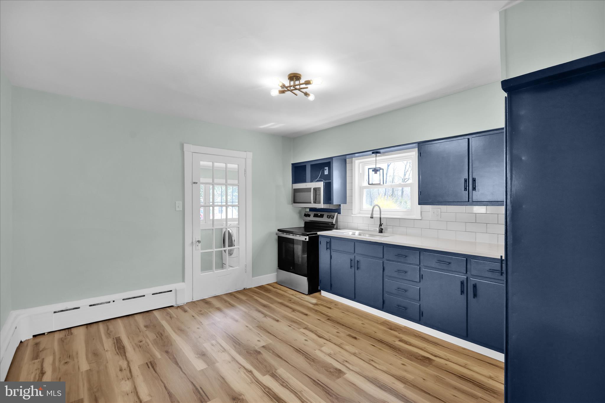 1425 Old River Road Birdsboro, PA 19508 - Photo 10 of 29 a kitchen with granite countertop a stove cabinets and wooden floor