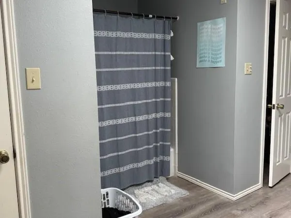 a view of front door with wooden floor