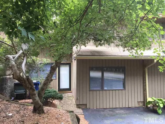 a house that has a tree in front of the house