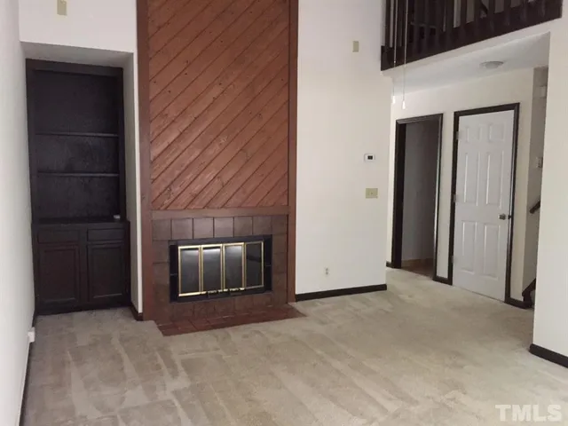 a view of an empty room with a fireplace