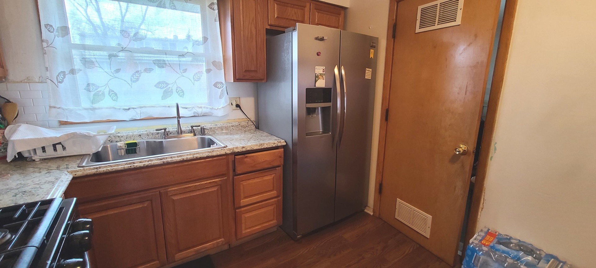 2423 Sand Lake Road Lindenhurst, IL 60046 - Photo 4 of 15 a kitchen with stainless steel appliances granite countertop a refrigerator and a sink