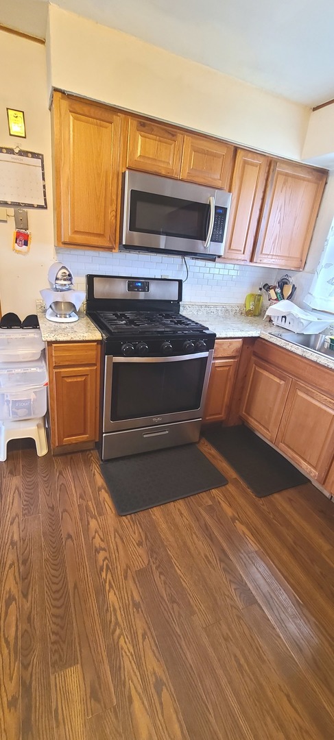 2423 Sand Lake Road Lindenhurst, IL 60046 - Photo 6 of 15 a kitchen with a stove a sink and a cabinets