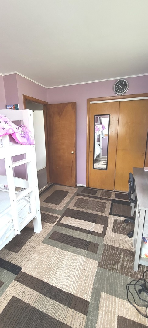 2423 Sand Lake Road Lindenhurst, IL 60046 - Photo 9 of 15 a bedroom with a bed and a window