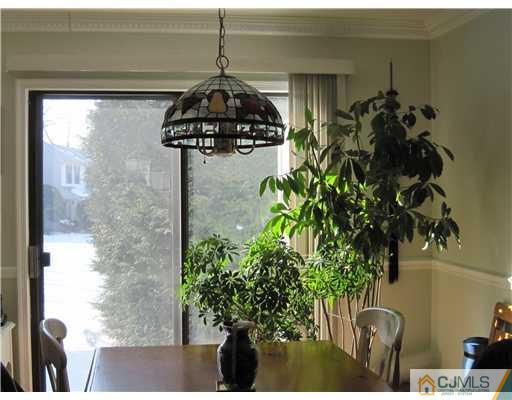 1202 Maplecrest Road Edison, NJ 08820 - Photo 5 of 10 a vase of flowers sitting on a table near a window