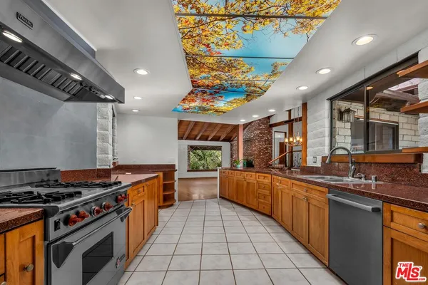 a kitchen that has a sink and a refrigerator