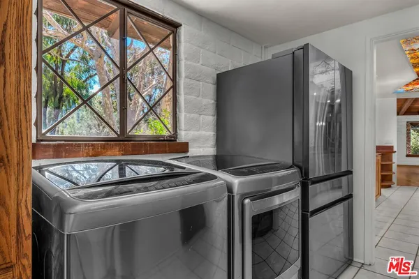 a stove top oven sitting inside of a kitchen