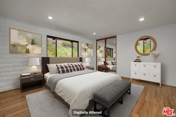 an empty room with wooden floor and natural light