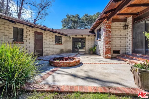 a view of backyard with swimming pool table and chairs