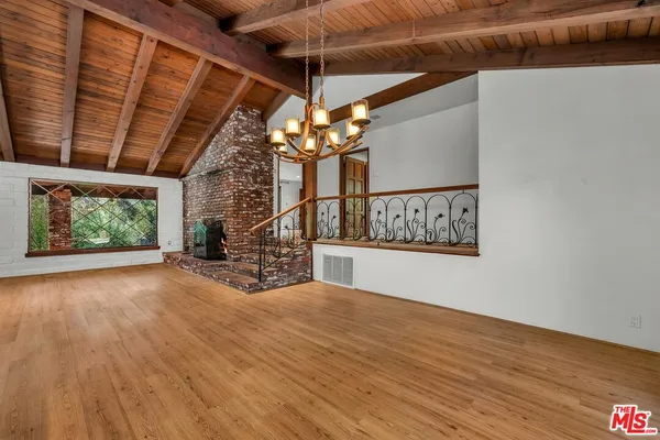 a large kitchen with stainless steel appliances granite countertop a stove a sink and a refrigerator