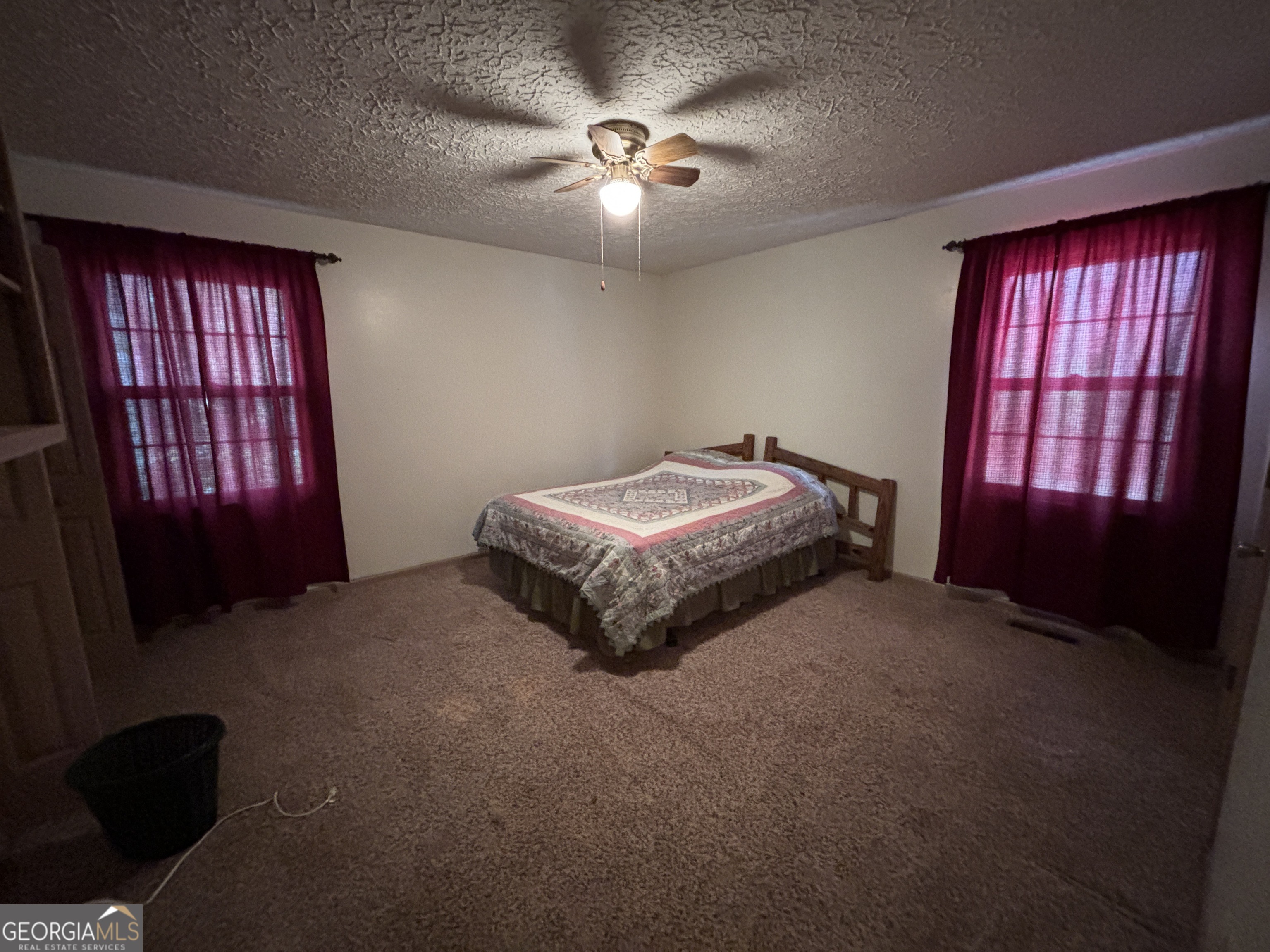 173 Berkley Road Cochran, GA 31014 - Photo 35 of 88 a spacious bedroom with a bed and a chandelier