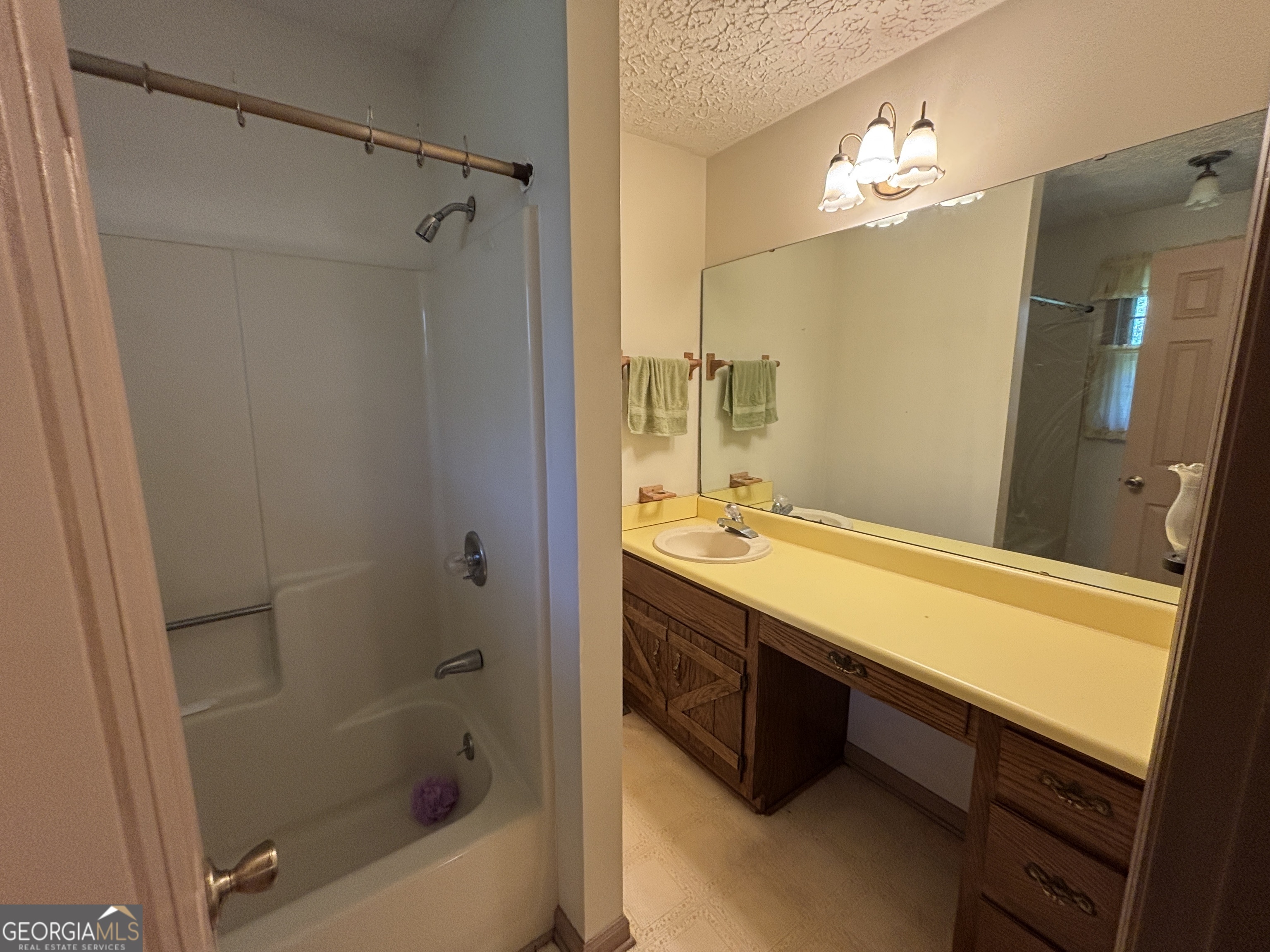 173 Berkley Road Cochran, GA 31014 - Photo 51 of 88 a bathroom with a double vanity sink a toilet and shower