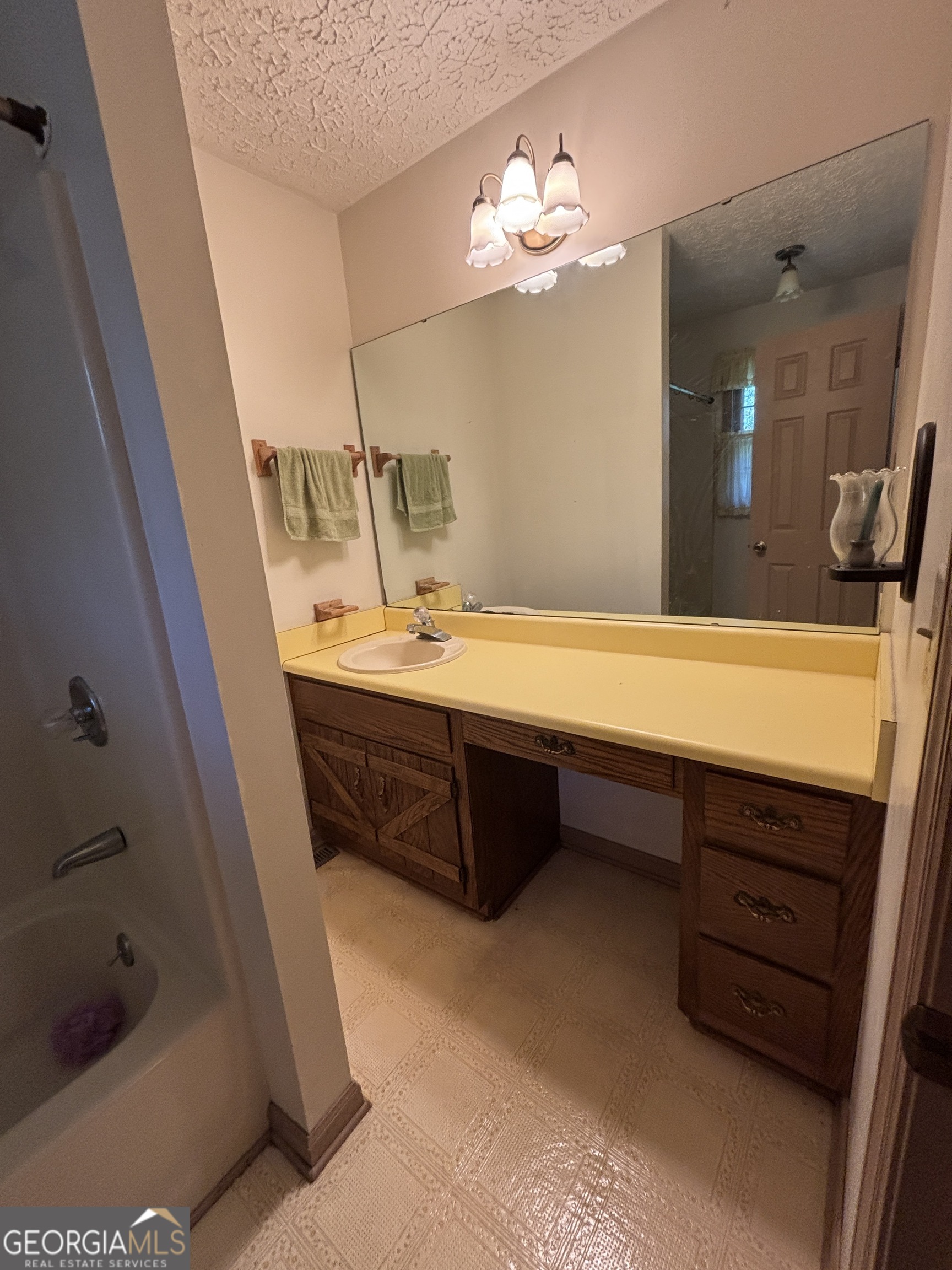 173 Berkley Road Cochran, GA 31014 - Photo 52 of 88 a bathroom with a sink a double vanity and a mirror