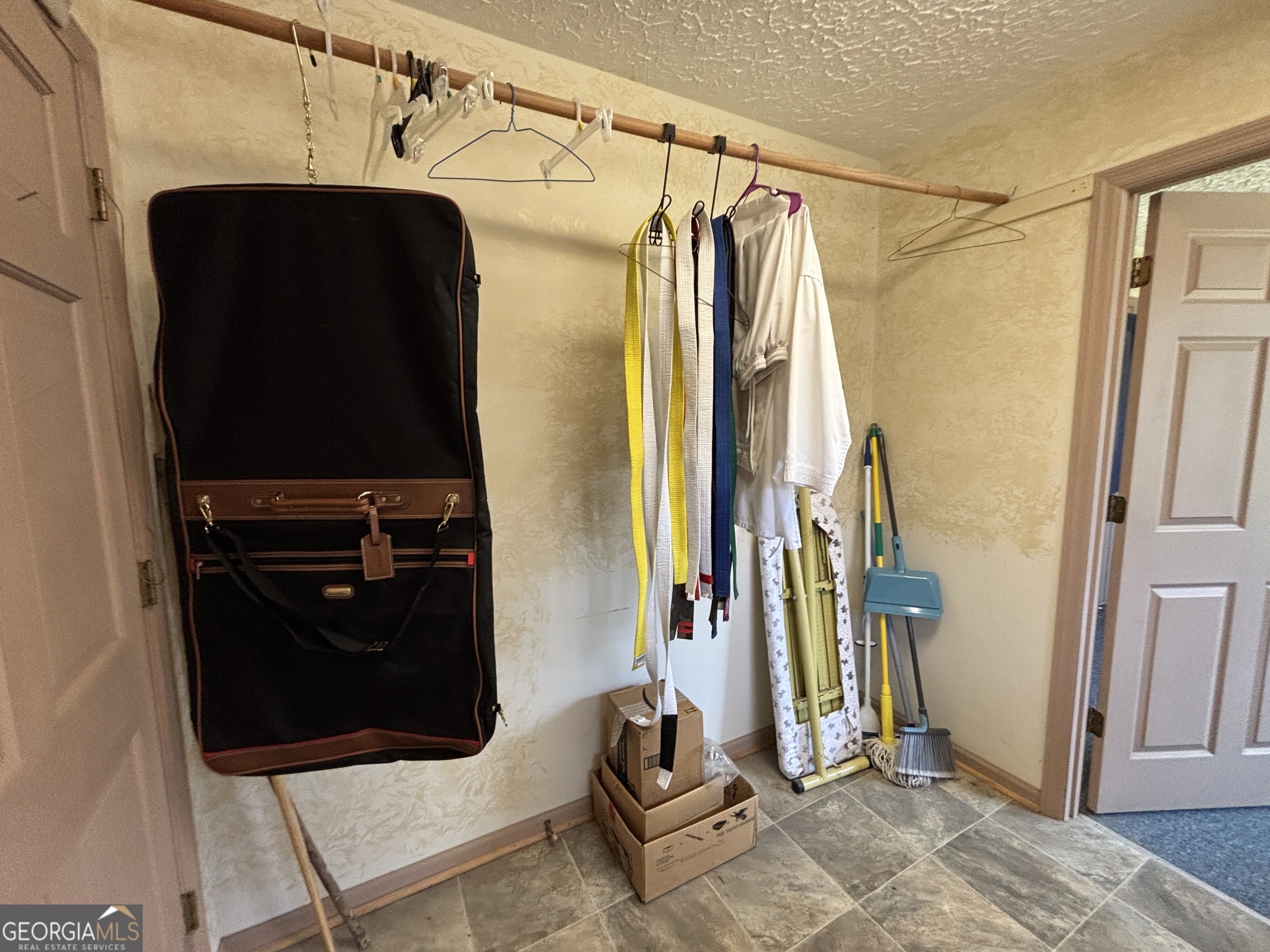 173 Berkley Road Cochran, GA 31014 - Photo 60 of 88 a view of walk in closet with clothes and shoes
