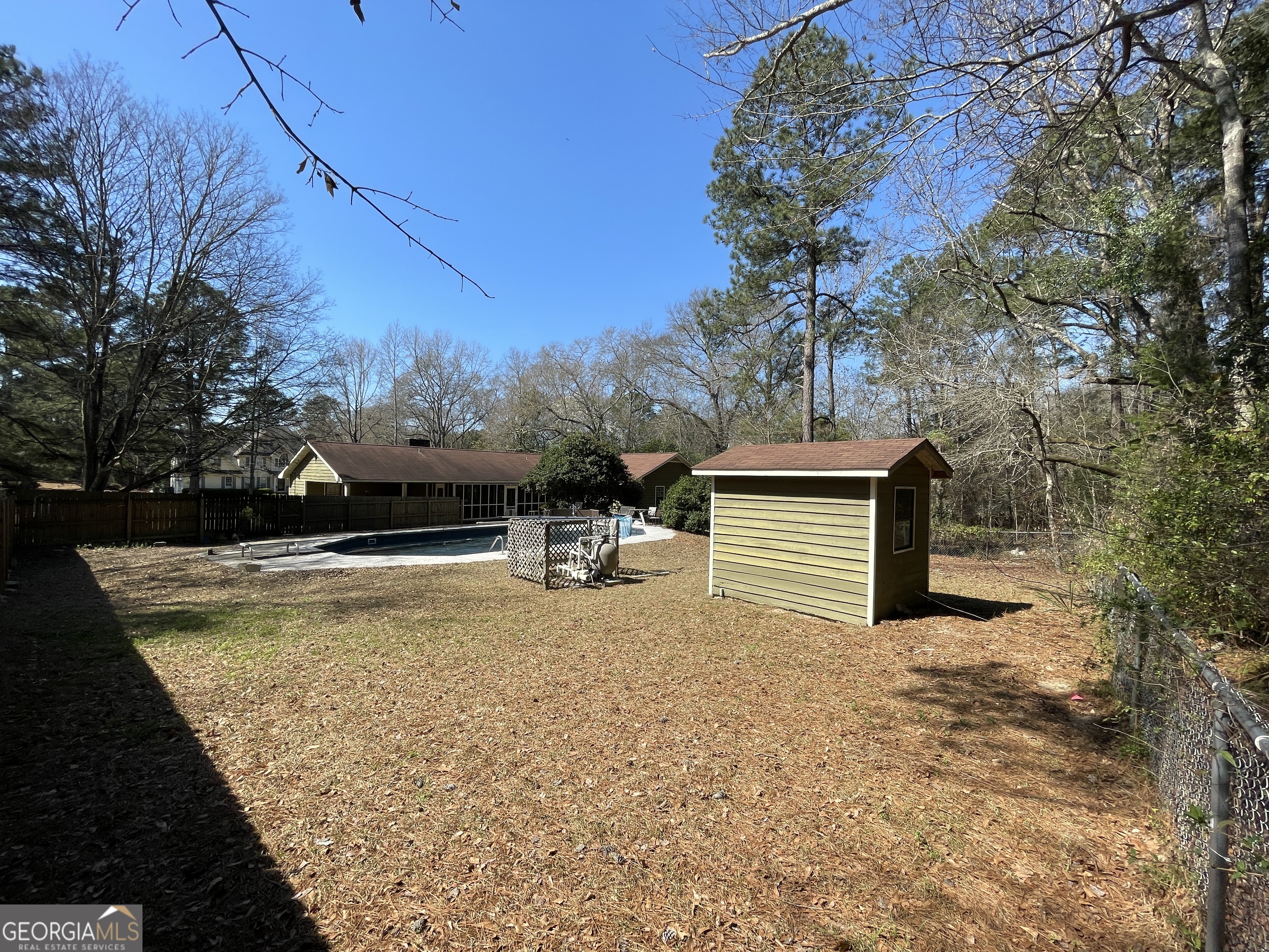 173 Berkley Road Cochran, GA 31014 - Photo 77 of 88 a view of a house with snow on the road and covered with trees