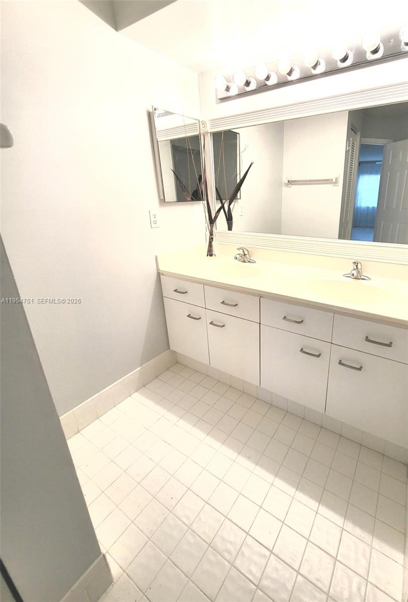 17286 Boca Club Boulevard, Unit 2108 Boca Raton, FL 33487 - Photo 13 of 25 a bathroom with a double vanity sink mirror and
