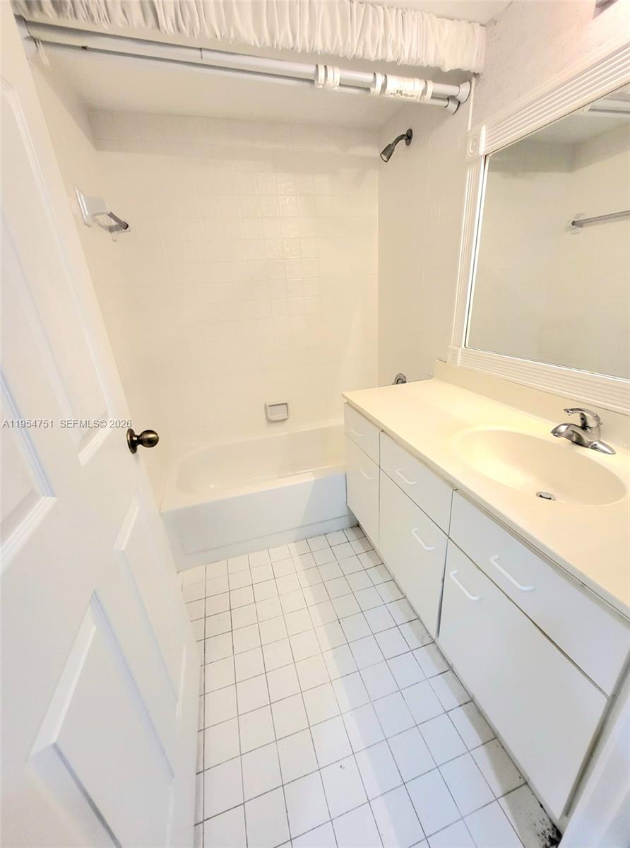 17286 Boca Club Boulevard, Unit 2108 Boca Raton, FL 33487 - Photo 16 of 25 a bathroom with a bathtub and shower