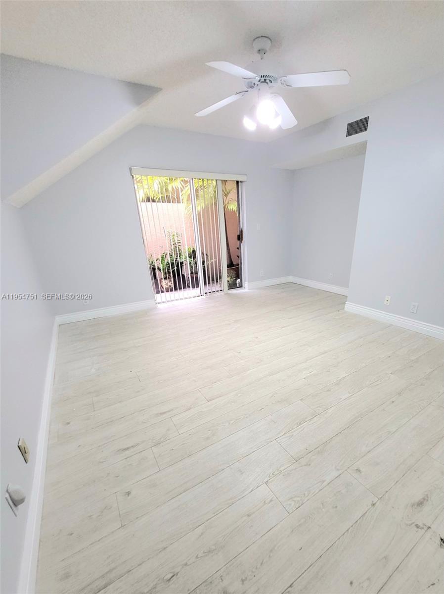 17286 Boca Club Boulevard, Unit 2108 Boca Raton, FL 33487 - Photo 18 of 25 an empty room with windows and fan
