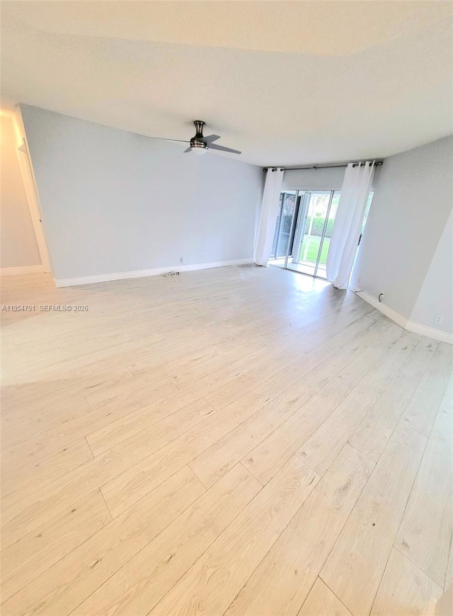 17286 Boca Club Boulevard, Unit 2108 Boca Raton, FL 33487 - Photo 3 of 25 an empty room with windows