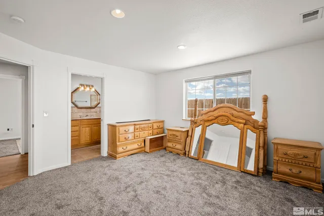 a bathroom with a toilet sink vanity tub and mirror