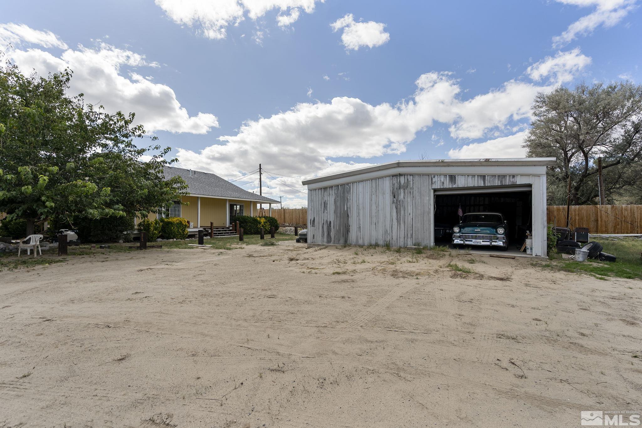 3300 Alcorn Road Fallon, NV 89406 - Photo 18 of 40 a front view of a house with a yard and a garage
