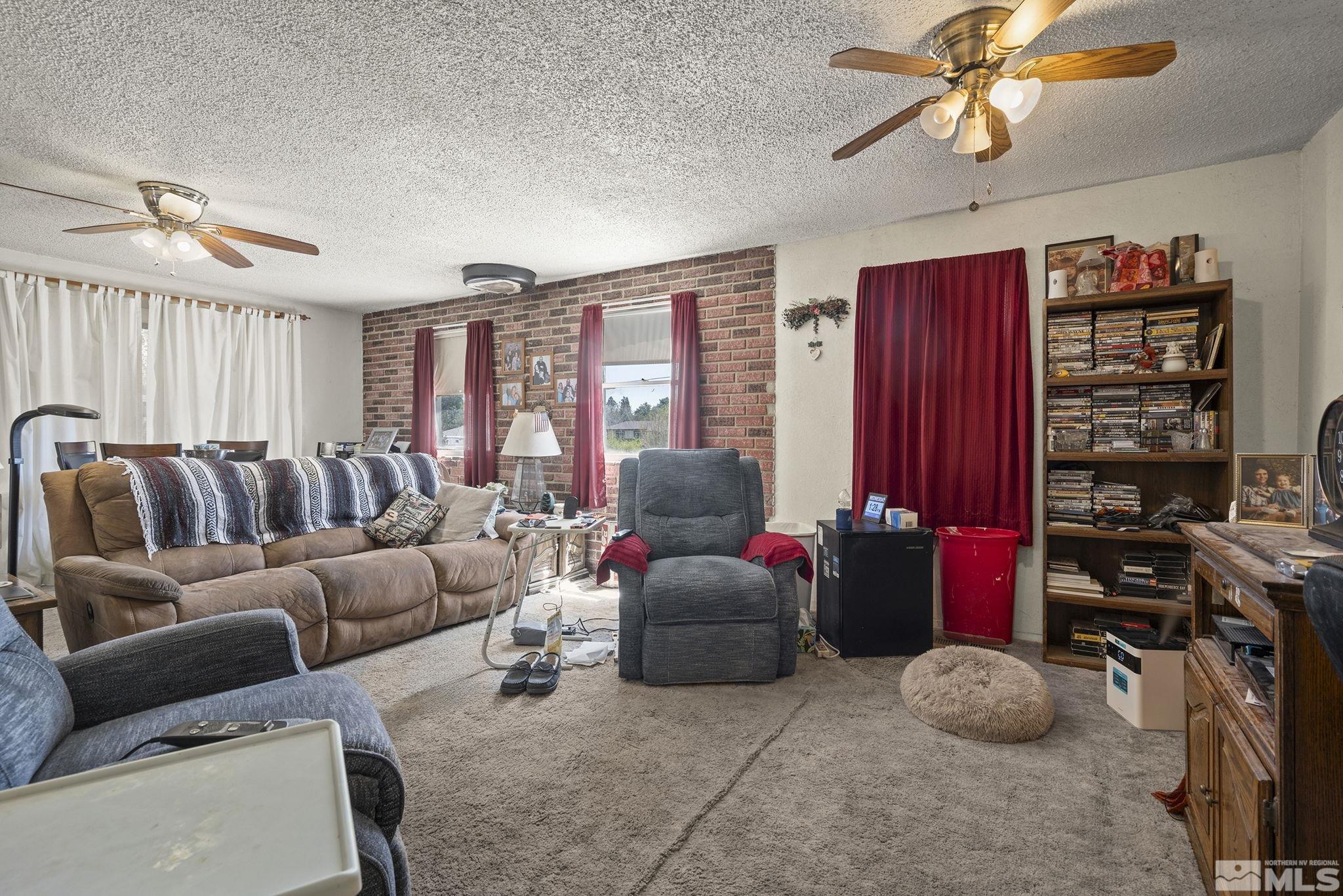 3300 Alcorn Road Fallon, NV 89406 - Photo 39 of 40 a living room with furniture a bookshelf and a window