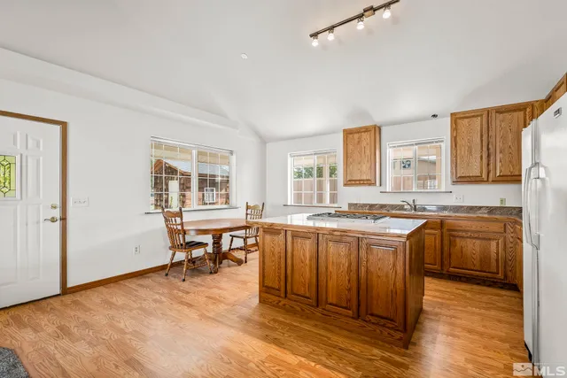 a large kitchen with a table and chairs in it
