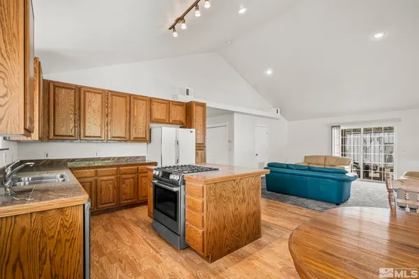 a kitchen that has a sink and a stove in it
