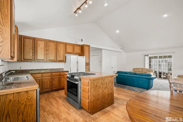 a kitchen that has a sink and a stove in it