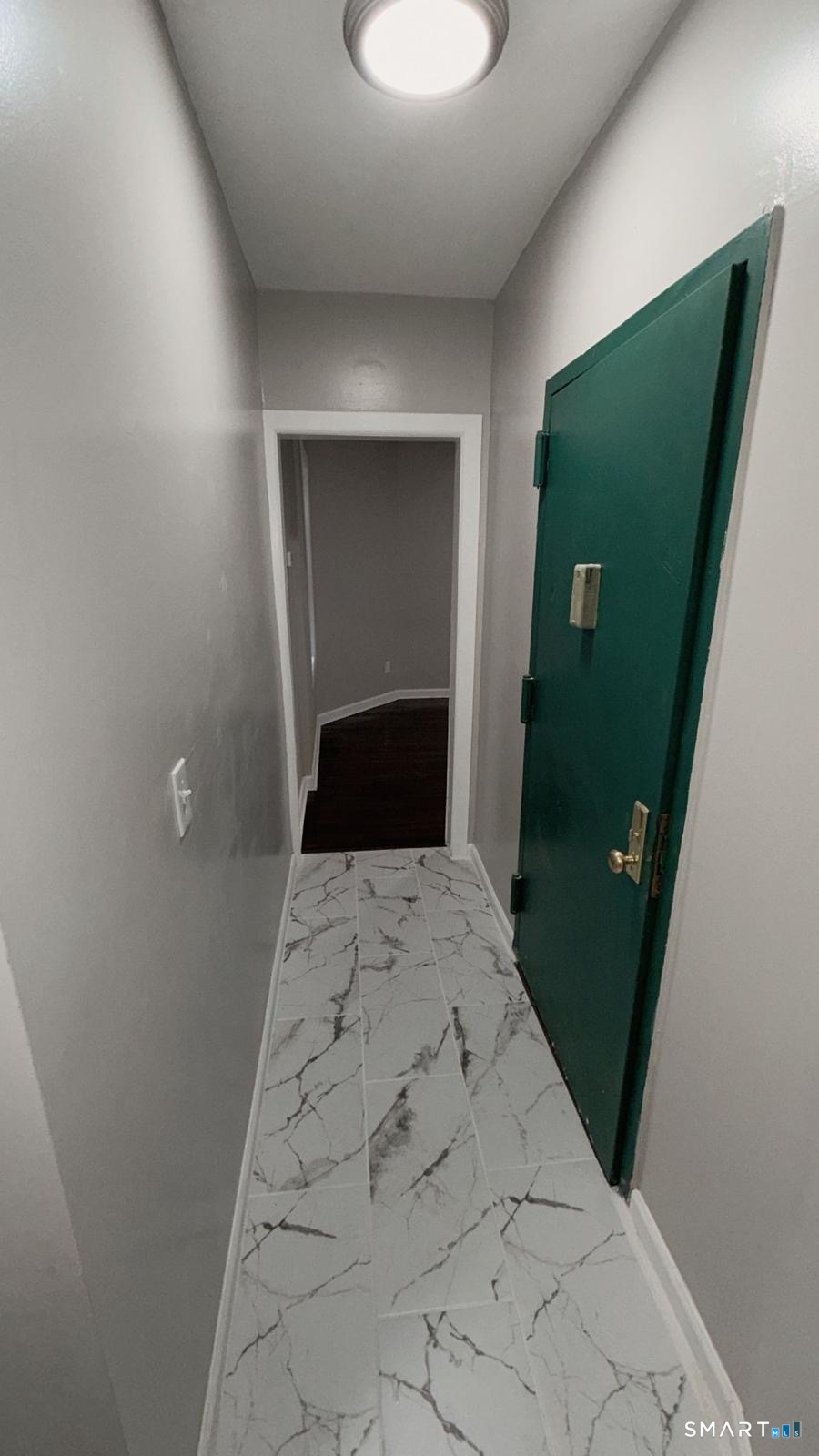 1071 Pembroke Street, Unit 1D Bridgeport, CT 06608 - Photo 5 of 5 a bedroom with a bed and a mirror