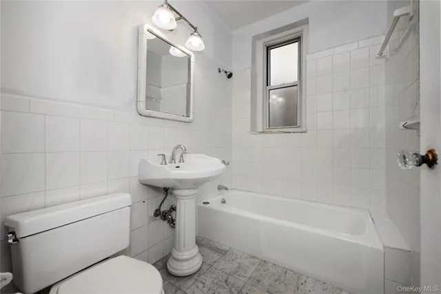 a bathroom with a sink toilet and bathtub