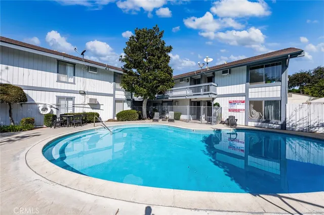 a view of house with swimming pool outdoor seating