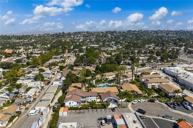 an aerial view of residential houses with city view