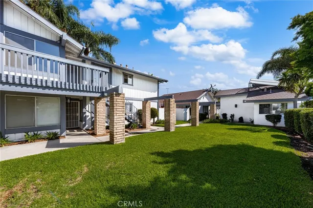 a front view of a house with a garden and sitting area