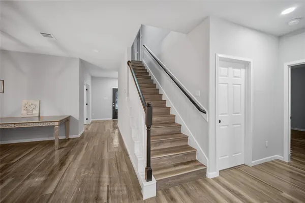 a view of a room with wooden floor and stairs