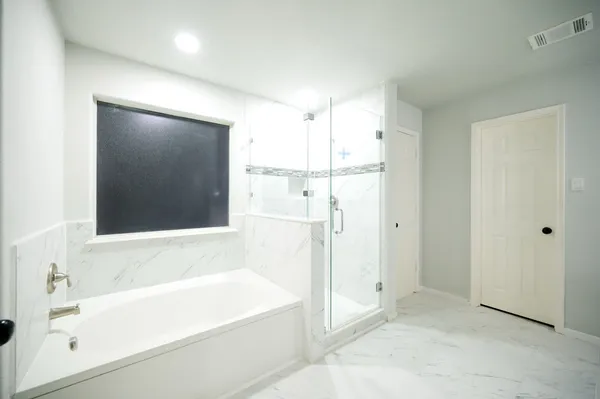 a bathroom with a bathtub and a shower