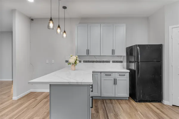 a kitchen with a sink stainless steel appliances and cabinets