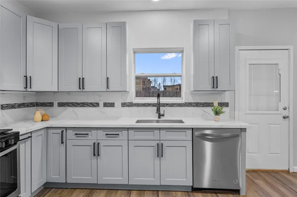 a kitchen with stainless steel appliances granite countertop a sink and cabinets