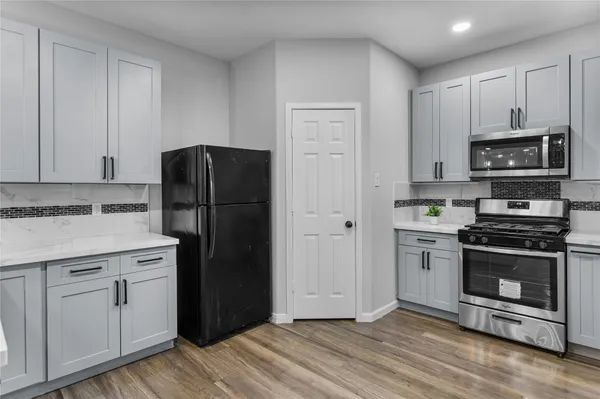 a kitchen with a refrigerator stove and microwave