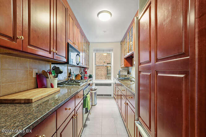 25 West Elm Street, Unit 40 Greenwich, CT 06830 - Photo 12 of 28 a kitchen with stainless steel appliances granite countertop a refrigerator