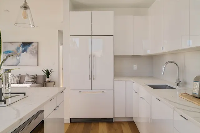 a kitchen with a sink and a refrigerator