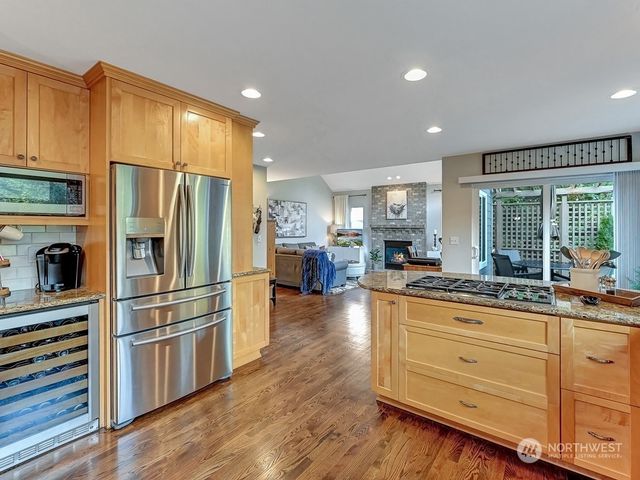 a kitchen with stainless steel appliances a refrigerator and a stove top oven