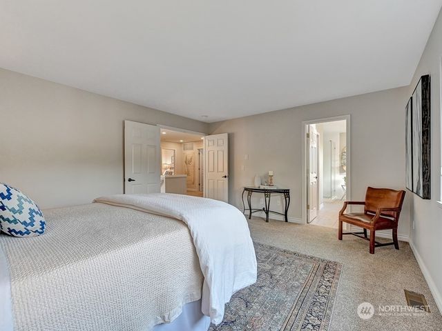 a bed room with a bed and a chair