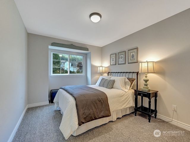 a bedroom with a bed and a night stand