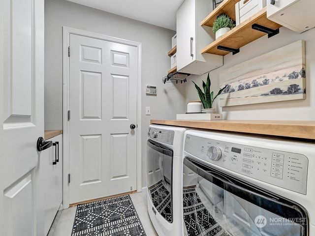 a view of a storage and utility room with washer and dryer