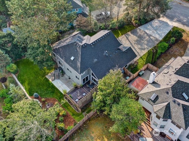an aerial view of multiple houses with yard